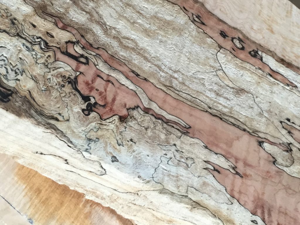 Close-up of spalted maple showing patches of color and dark zone lines