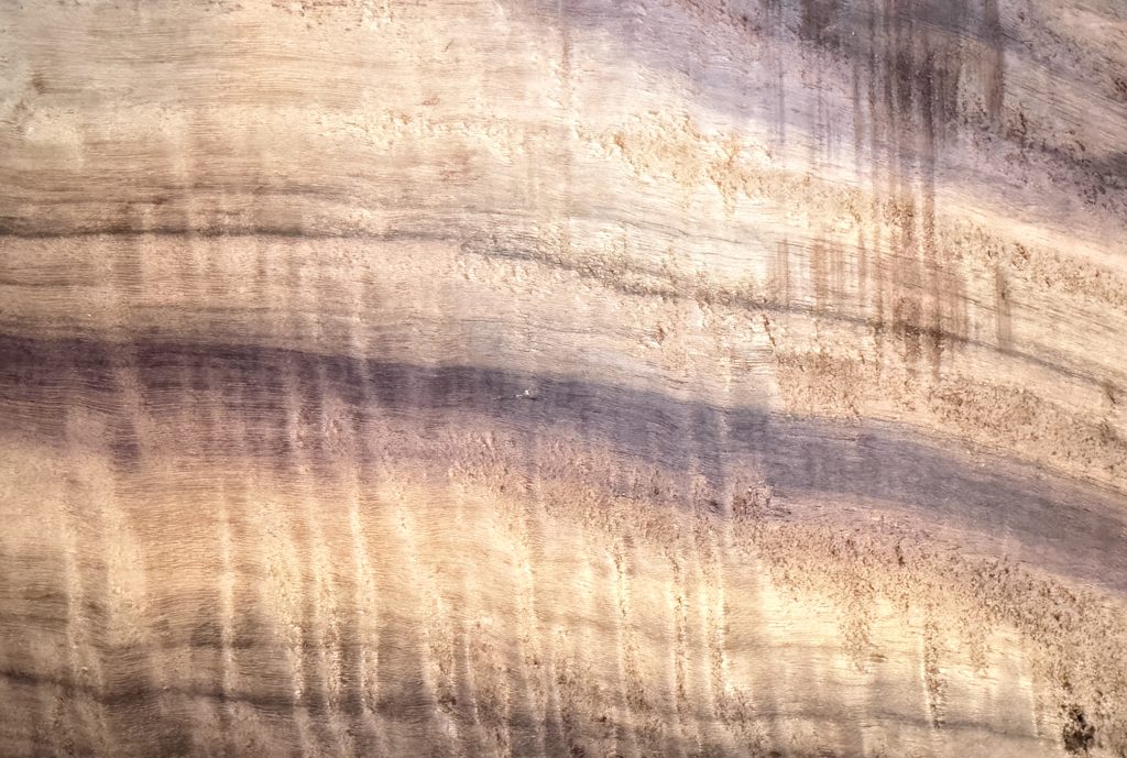 Figured katalox board with rippling purple and gold tones