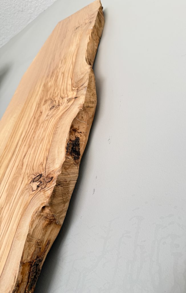 Olivewood slab close-up showing wild, contrasting grain