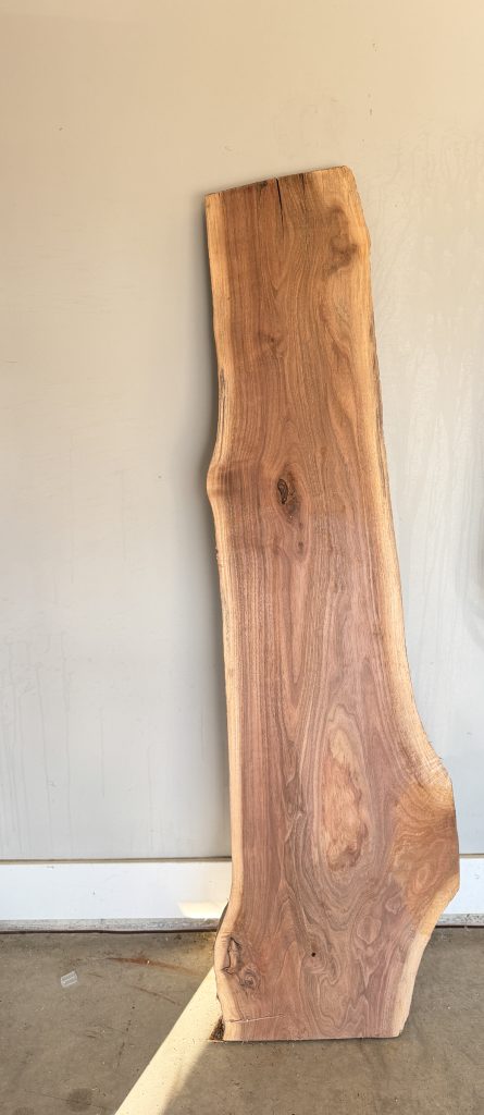 Black walnut live-edge slab with rich heartwood and a sculpted edge