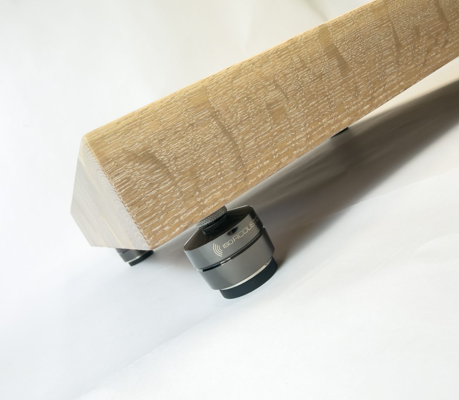 Low-angle view of the white oak platform and its isolation feet