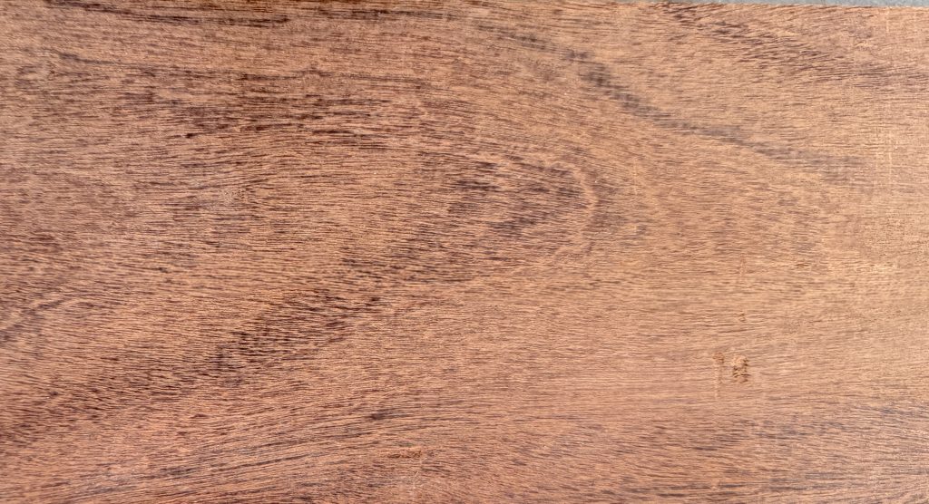 Afrormosia board with golden-brown heartwood and darker stripes