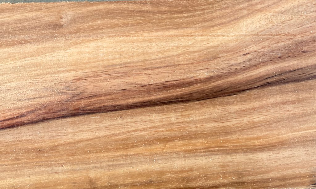 Canary wood with golden yellow and orange tones and dark streaks
