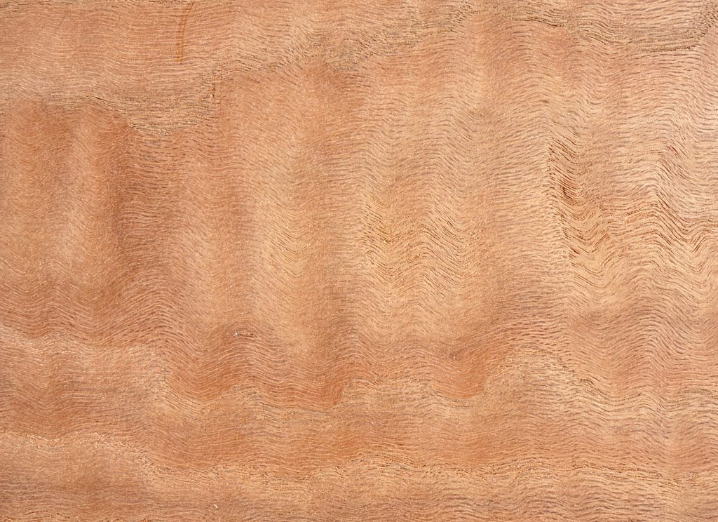 Red oak board with pinkish tone and rippling figure