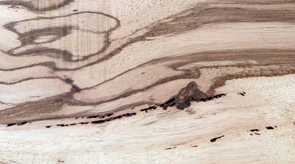 Flatsawn zebrawood board with bold, wavy dark stripes